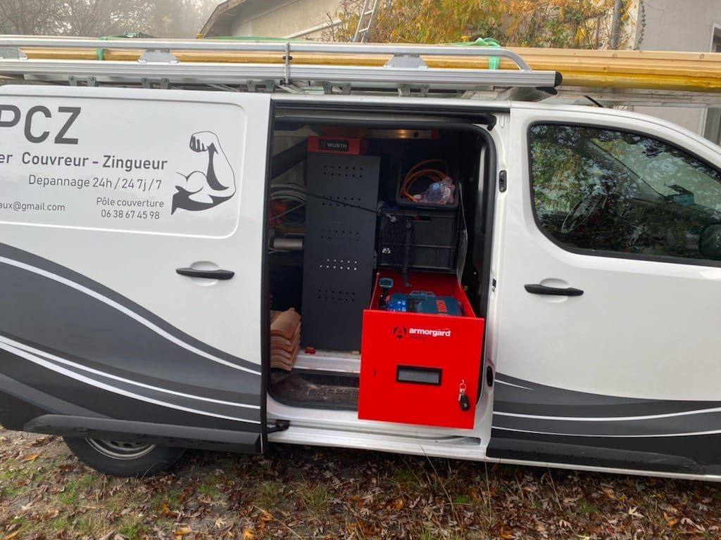 A van with it's sliding door on the side of the van open and shows the inside with some tools and also a red Armorgard TrekDror draw pulled open.
