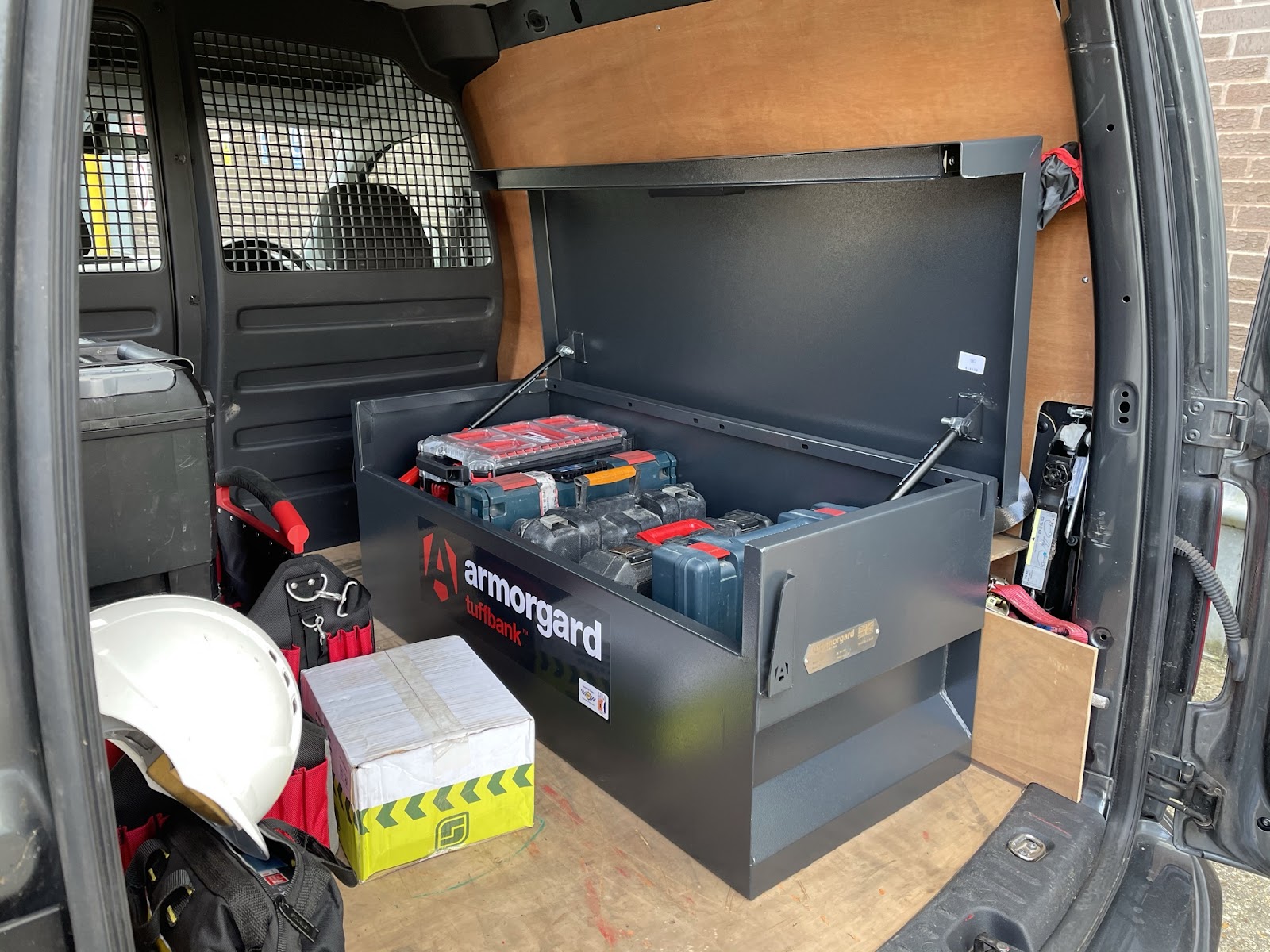 An Armorgard tuffbank with 5 tool boxes inisde the back of a van