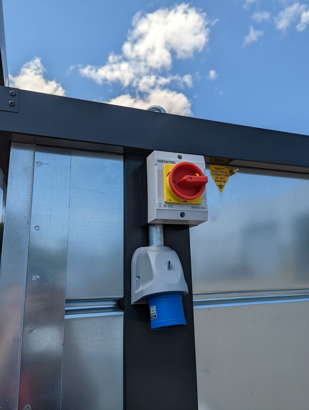A red switch that looks like it can be turned on the side of a armorgard storage unit