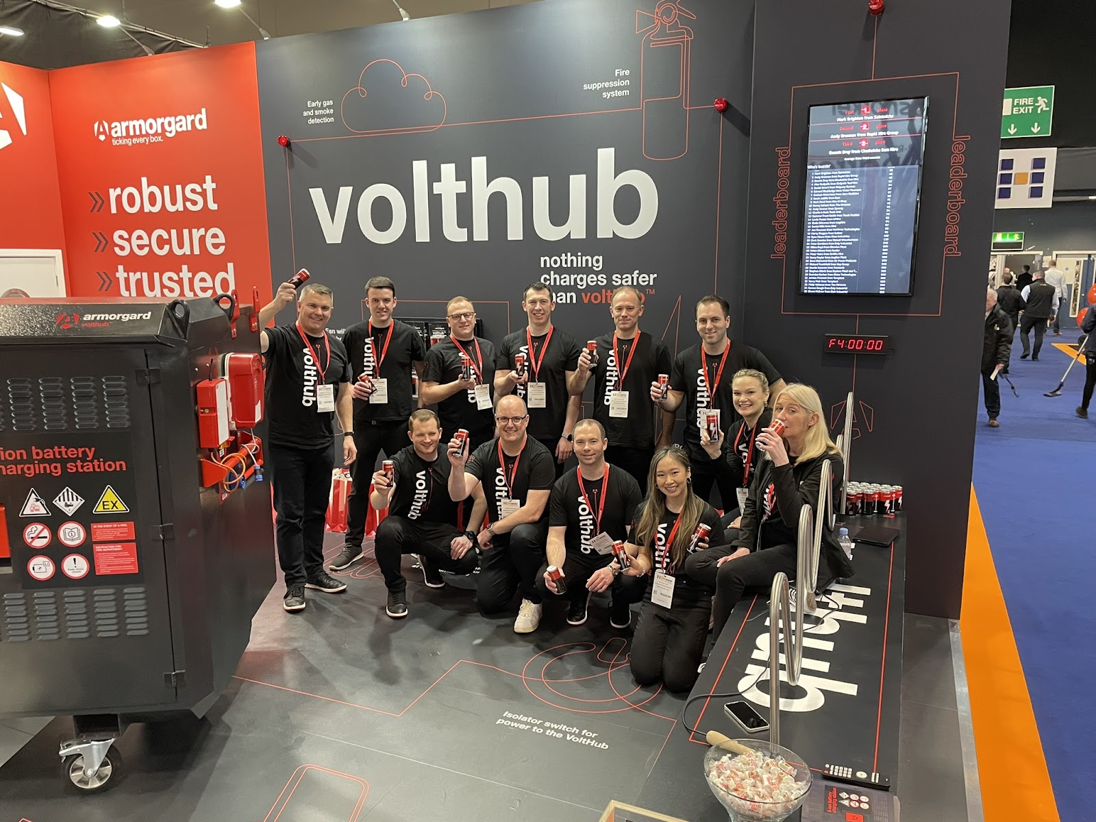 Group of 12 Armorgard employees at the Executive Hire Show showcasing their product VoltHub used to charge lithium-ion batteries