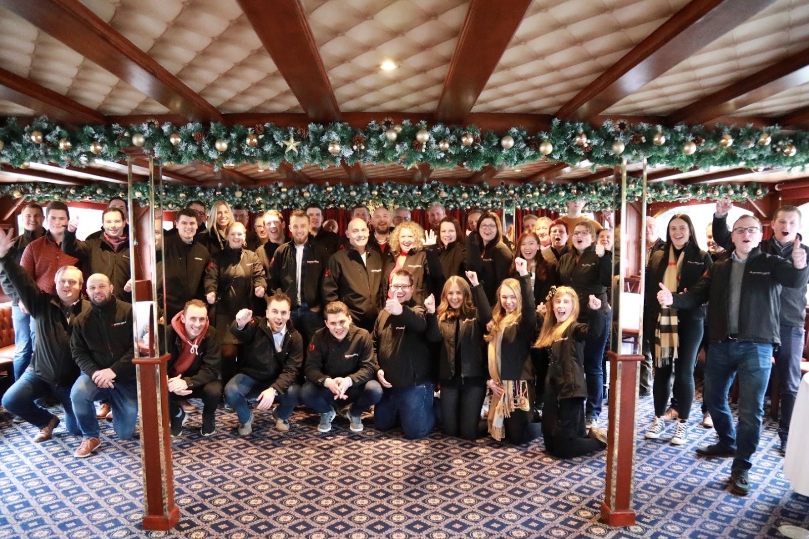 Very large group of Armorgard employees posing for a group photo, smiling and showing general happy expressions