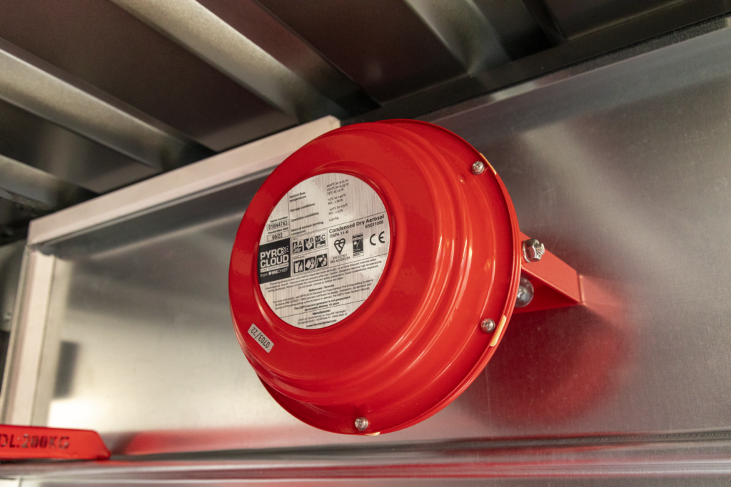 A red and round power suppression system attached to a metal service