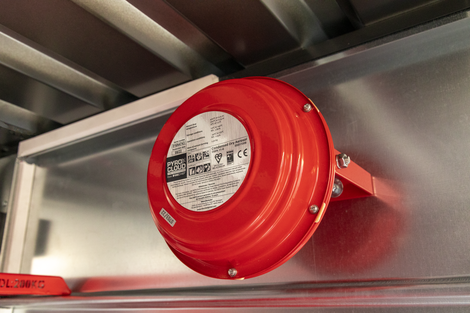 A red and round power suppression system attached to a metal service