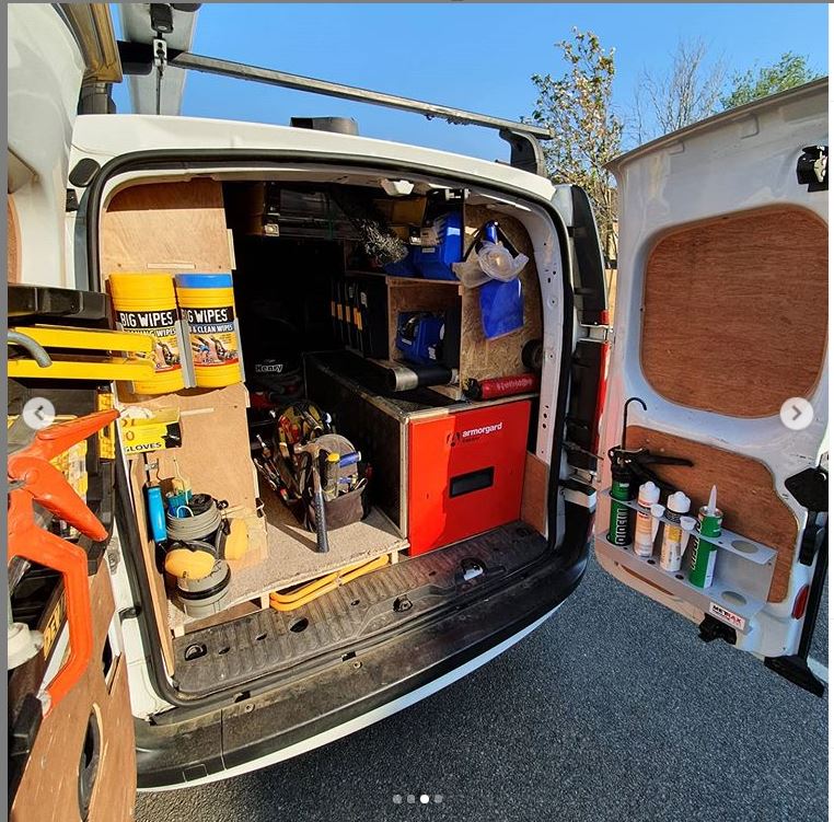 the back of a van with its doors open there is some cleaning products and building materials such as hammers, there is an armorgard trekdror on the bottom right of the van