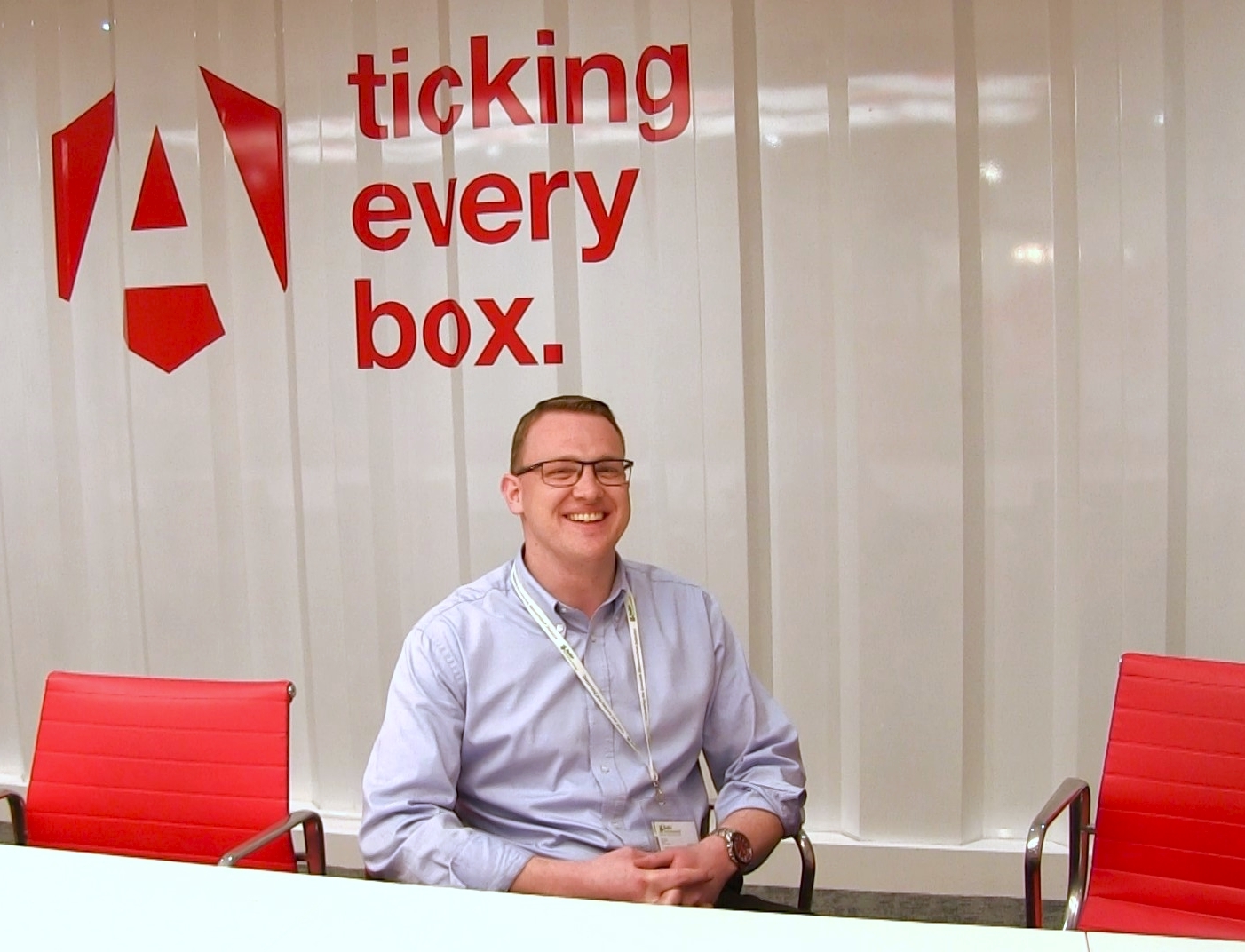 A man with glasses called Jeremy sitting on a chair with an Armorgard logo in the background